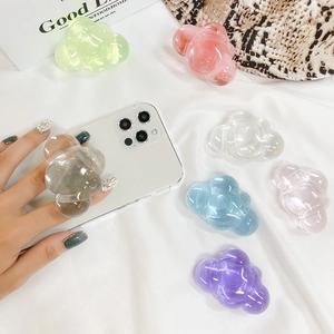 Cloud-shaped resin phone socket grip in pastel colors shown on white silk background