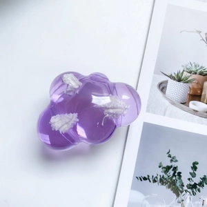 Detail of purple cloud-shaped phone socket with semi-transparent texture and cotton inlay
