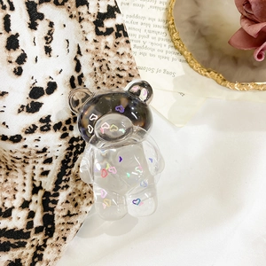 Detail of a cute transparent bear phone grip with colorful heart sequins and brown head