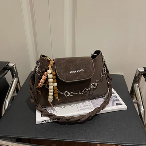 Dark brown suede chain bag with woven strap and decorative beaded star charms