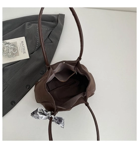 Deep brown leather tote bag interior view with zipper pocket and decorative silk scarf