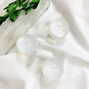 Close-up of pearlescent white gradient glitter cell phone socket grips on white fabric