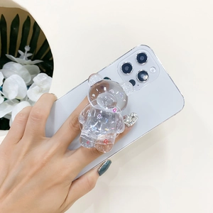 Detailed view of clear resin bear phone grip with colorful mini hearts on a white phone