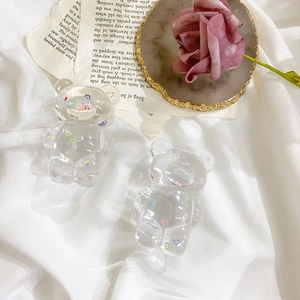 Detailed close-up of transparent acrylic bear phone grips with colorful heart patterns