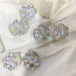 6-piece set of holographic cat paw phone socket stands on a white textured fabric background