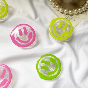 Transparent retractable smile face phone grip holder with colorful graffiti patterns
