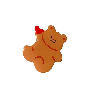 Detail of cute brown acrylic bear phone socket with glossy finish and red heart accent