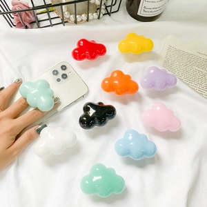Close-up of glossy cloud-shaped phone socket grips in vibrant multiple colors