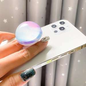 Détail d'un support de téléphone télescopique avec motif de planète nébuleuse sur mobile