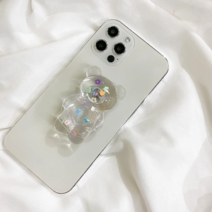 Detailed view of a transparent bear phone grip with colorful floral and heart patterns