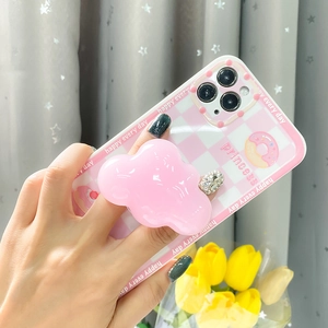 Detail showing pink checkered phone case with a large 3D cloud retractable pop socket