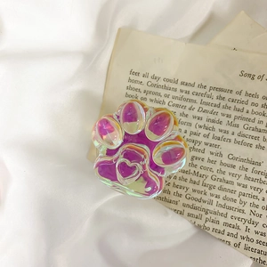 Detailed macro view of a 3D resin cat paw phone grip with colorful laser gloss