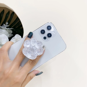 Détail d'un support de téléphone patte de chat transparent à paillettes sur un smartphone