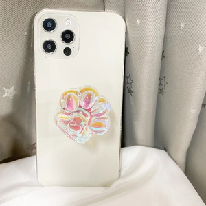 Macro detail of 3D laser iridescent cat paw phone socket holder on white smartphone