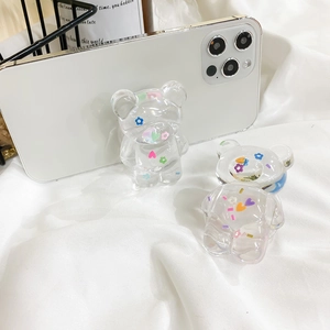 Detail of transparent bear phone grip featuring colorful flower and heart resin inserts