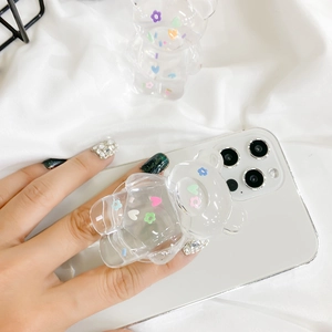 Macro detail of a transparent bear phone grip with colorful floral and heart patterns