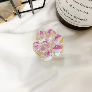 Detailed view of iridescent holographic cat paw phone grip with heart relief design