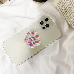 Close-up of cat paw phone socket with iridescent aurora finish on a white smartphone