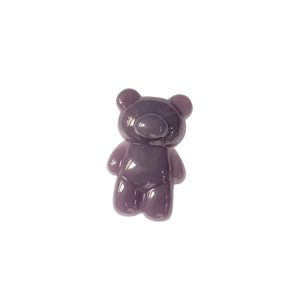 Close-up of a deep purple bear-shaped phone grip with a glossy resin gummy texture