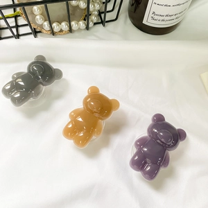 Three glossy bear-shaped phone grip sockets in grey, light coffee, and purple colors