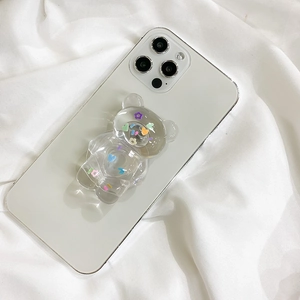 Transparent 3D bear phone grip with colorful heart and flower patterns on white case