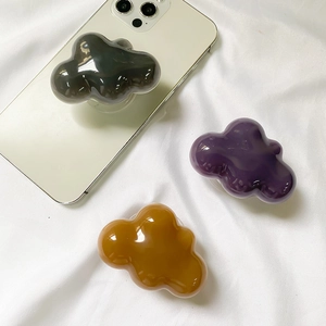 Glossy cloud shaped phone sockets in black purple and brown on white phone
