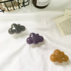 Glossy cloud-shaped expandable phone grip holder in vintage colors on silk background