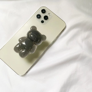 3D retro bear phone grip holder in translucent grey on a white smartphone