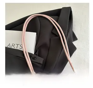 Detail of pink leather handle and lace pattern on a stylish women shoulder bag