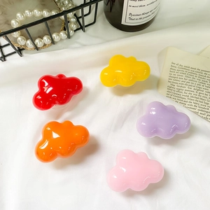 Cloud-shaped glossy phone grip sockets in multiple colors on a stylish desk setup