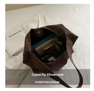 Interior view showing the large capacity of the brown tote bag with daily essentials