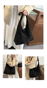 Detail of hobo leopard tote bag with matching inner pouch on beige sweater background