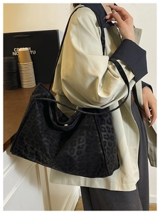 Detail of black leopard print tote bag with soft texture and wide shoulder straps