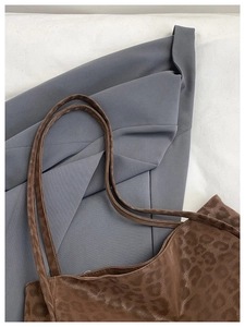 Detail of vintage leopard print tote bag with soft satin texture and slim shoulder straps