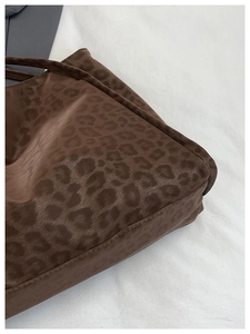 Close-up of leopard print tote bag fabric showing fuzzy texture and detailed stitching