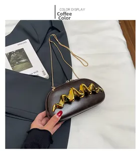 Detail of coffee brown wave clutch with gold metal accent and elegant chain strap