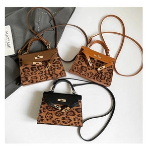 Flat lay of retro leopard print square bags with leather flaps and metallic lock details