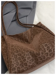 Close-up of leopard print tote bag with soft velvet texture and dual shoulder straps