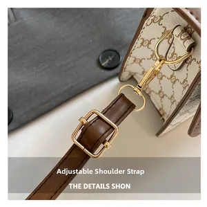 Close-up of adjustable leather shoulder strap with gold-tone buckle on crossbody bag