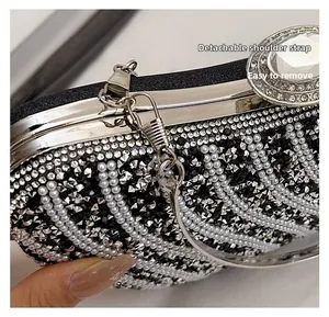 Detail showing the detachable silver chain strap and sparkling rhinestone inlay on a black bag