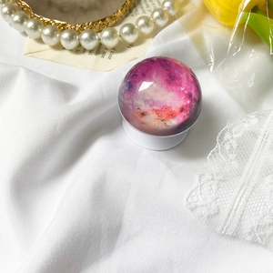 Retractable phone socket with purple nebula star pattern and white circular base