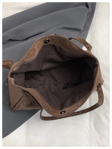 Detail of leopard print tote bag interior showing the magnetic clasp and brown lining