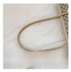 Detail of the vintage monogram tote bag featuring long slender leather shoulder straps
