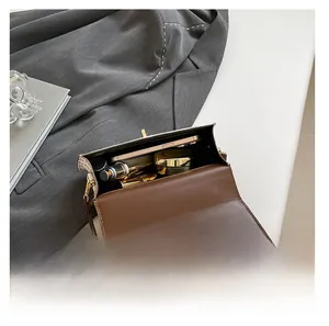 Interior storage space of the brown leather crossbody bag with phone and lipstick