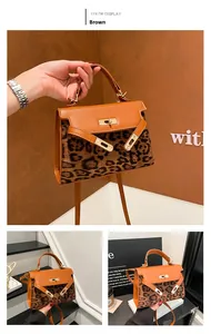 Detailed close-up of brown leopard print texture and golden twist lock on Kelly bag