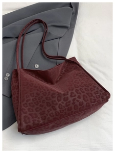 Detailed view of dark burgundy leopard print tote bag with premium matte texture on fabric