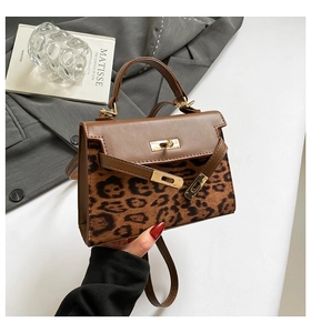 Close-up of leopard print texture and metal lock on the brown Kelly crossbody bag