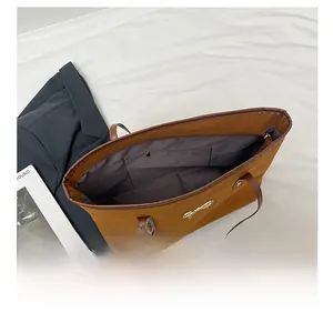 Detail view of the spacious brown tote bag interior with a functional zipper pocket