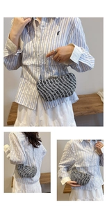 Macro view of sparkly rhinestone square evening bag with wavy patterns and silver chain