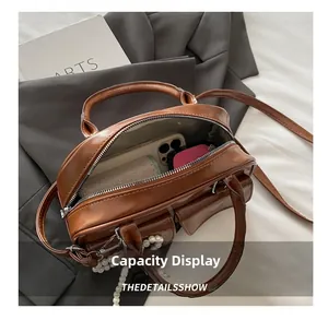Internal view of caramel faux leather handbag showing capacity for essentials and zip closure